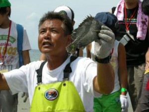 地引網で獲れた魚を配る人